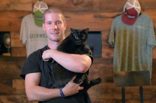 Karl Merton Ferron / Baltimore Sun
Diamondback Brewing Company co-founder and head brewer Tom Foster holds Inky, a cat the brewery received from the Working Cats program in Baltimore.