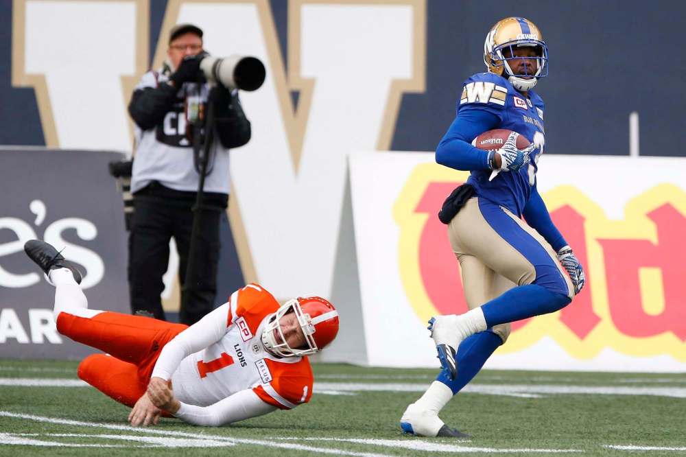B.C. Lions kicker Ty Long (1) can't stop Winnipeg Blue Bombers defensive back Kevin Fogg (3) as he returns his kick for the touchdown during the first half of CFL action in Winnipeg on Saturday, October 14, 2017. THE CANADIAN PRESS/John Woods