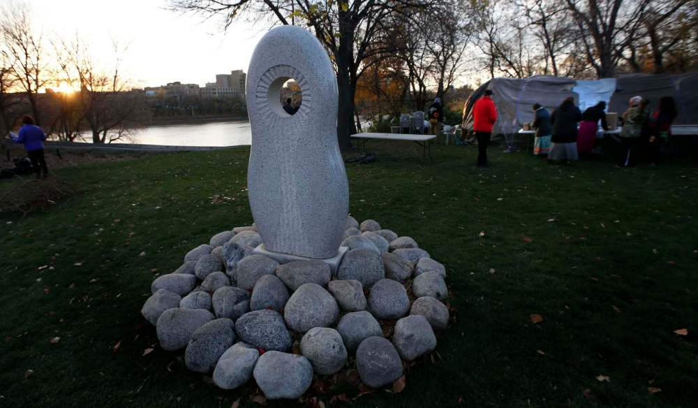 A sunrise ceremony was held Monday morning by the monument in honour of Manitoba’s missing and murdered Indigenous women and girls at The Forks to mark the start of the commission's hearings in Winnipeg. (Wayne Glowacki / Winnipeg Free Press)