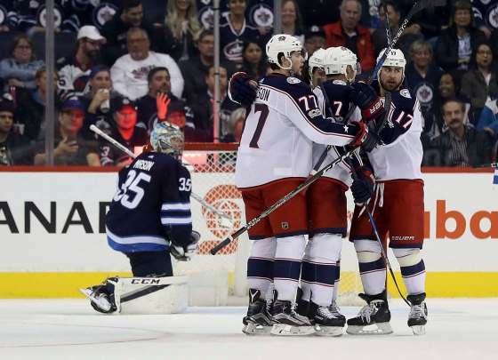 THE CANADIAN PRESS/Trevor HaganColumbus Blue Jackets players celebrate after Jack Johnson scored on Winnipeg Jets goaltender Steve Mason during second period NHL hockey action in Winnipeg, Tuesday.