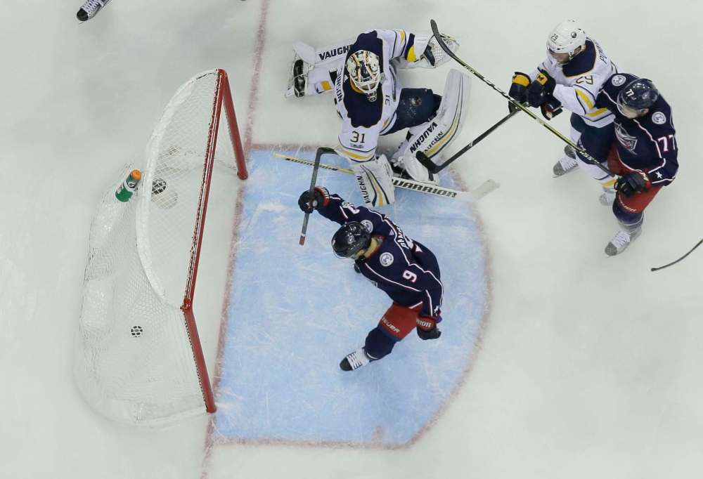 ADAM CAIRNS/ COLUMBUS DISPATCH
Artemi Panarin (9) watches the puck go into the net, fired by defenseman Seth Jones, not pictured, past Buffalo Sabres goalie Chad Johnson (31) on Wednesday.