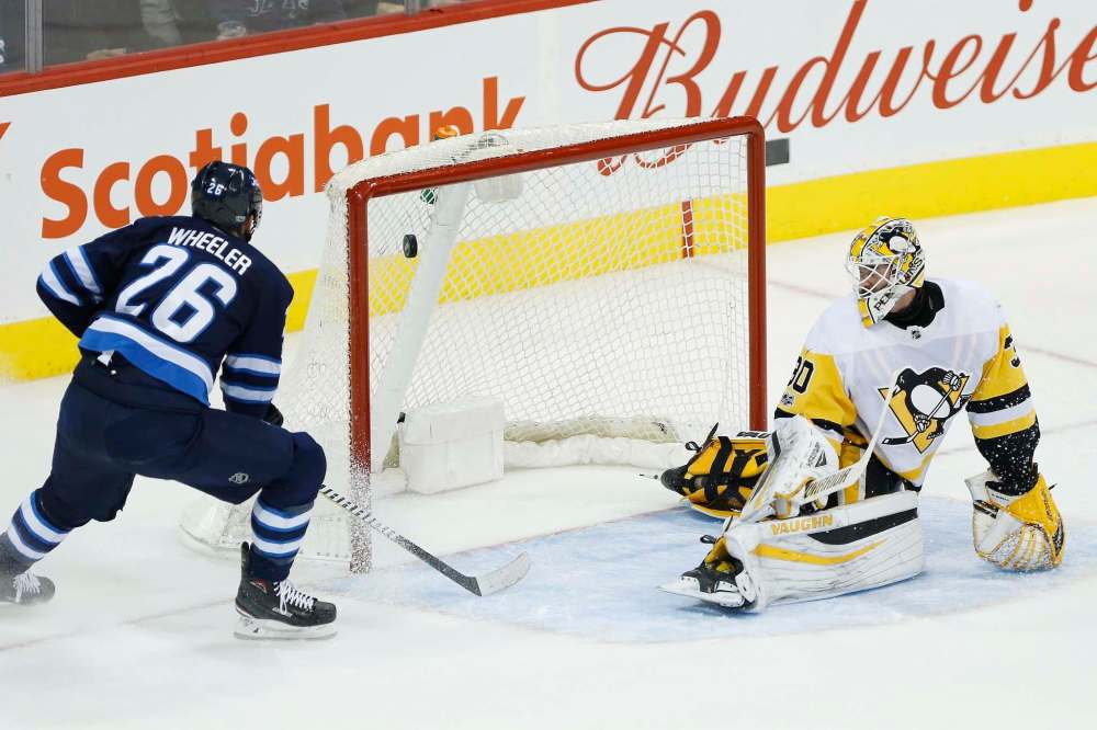 John Woods / The Canadian Press
Jets's captain Blake Wheeler scores one of his three first period goals against Penguins goalie Matthew Murray, who was pulled after allowing four goals on nine shots.
