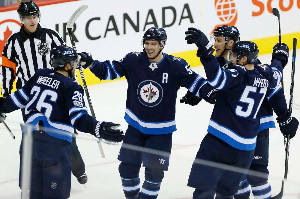 JOHN WOODS / THE CANADIAN PRESS
Winnipeg Jets Blake Wheeler, Mark Scheifele, Shawn Matthias and Tyler Myers celebrate one of Wheeler's three first period goals against Pittsburgh Sunday.