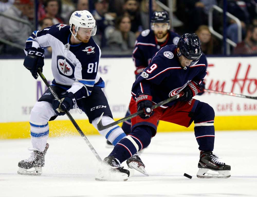 Paul Vernon / The Associated Press files
Winnipeg Jets forward Kyle Connor battles for the puck with the Blue Jackets’ Artemi Panarin during an NHL game in Columbus Oct. 17.