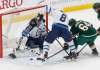 Winnipeg Jets goalie Connor Hellebuyck, left, and Jacob Trouba, center, defend as Minnesota Wild's Mikael Granlund of Finland tries to reach the rebound during the first period of an NHL hockey game Tuesday, Oct. 31, 2017, in St. Paul, Minn. (AP Photo/Jim Mone)