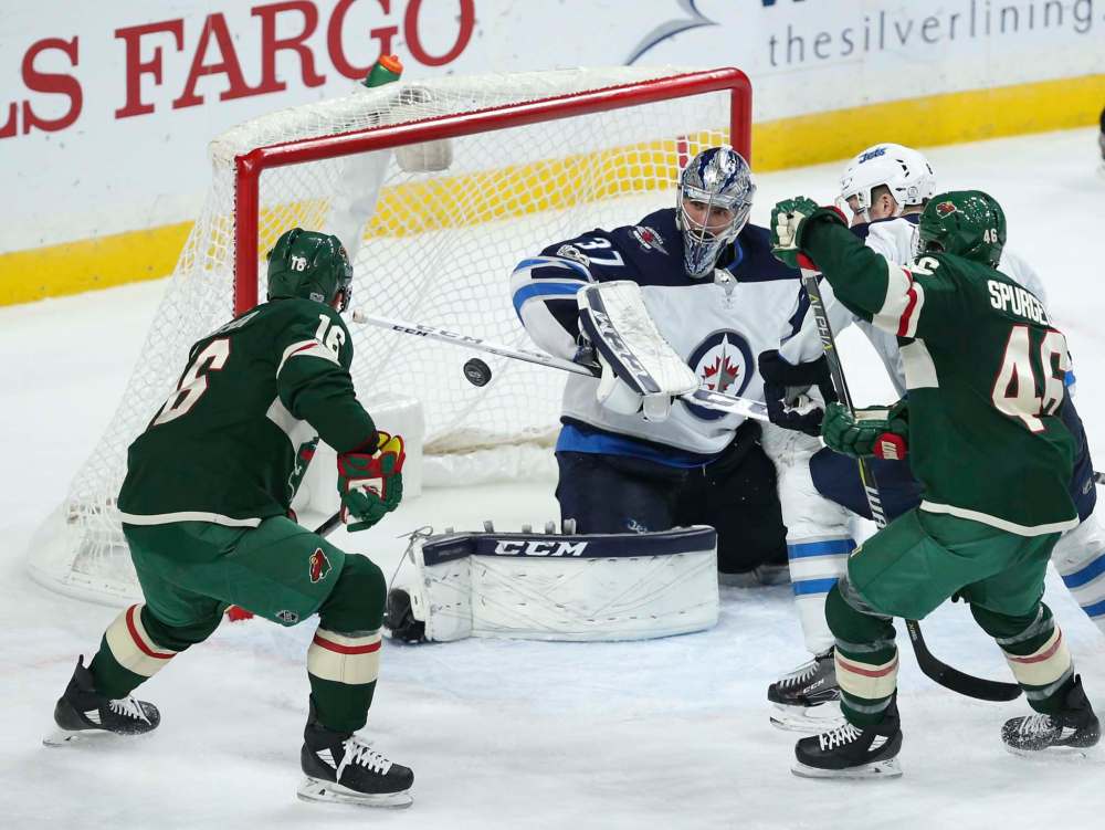 Jeff Wheeler/Minneapolis Star Tribune
Winnipeg goalie Connor Hellebuyck keeps his eye on the puck late in the third period of the Jets' 2-1 victory over the Wild on Tuesday, in St. Paul, Minn.