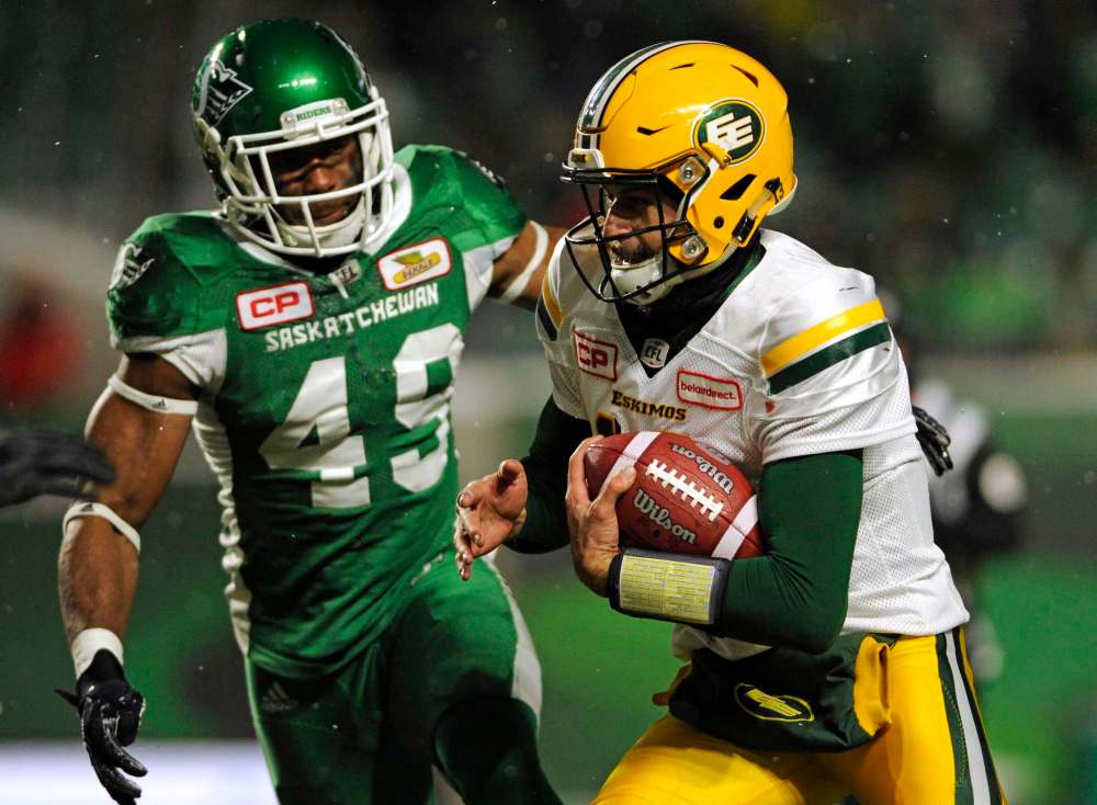 Mark Taylor / The Canadian Press
Edmonton Eskimos quarterback Mike Reilly runs the ball as Saskatchewan Roughriders’ Jeff Knox Jr. chases during first half CFL football action at Mosaic Stadium in Regina on Saturday, November 4, 2017.