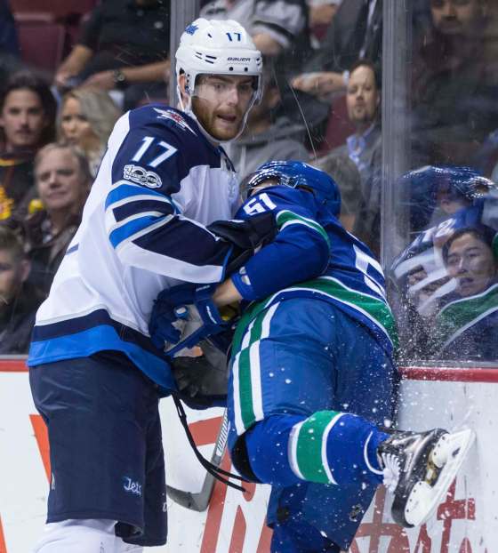 DARRYL DYCK / THE CANADIAN PRESS FILESWinnipeg Jets centre Adam Lowry (left) has not played since Oct. 12 due to an upper-body injury.