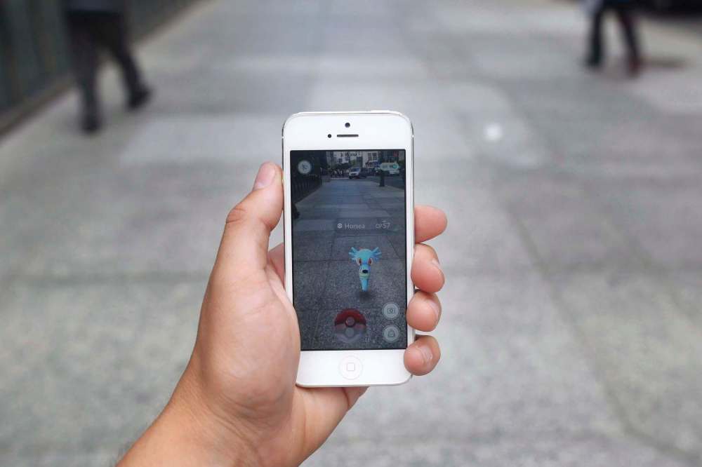 THE CANADIAN PRESS/Cole Burston
A Pokemon appears on a smartphone playing Pokemon Go. A Winnipeg school board trustee is calling for clearer rules about when public school students and staff can have their cell phones seized and searched.