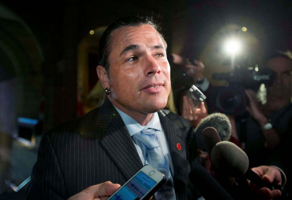 Justin Tang / The Canadian Press
Senator Patrick Brazeau speaks to reporters as he arrives at the Senate on Parliament Hill.