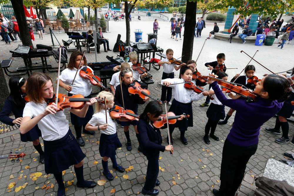 The St.Charles Catholic School’s Junior Violin Ambassadors warm up with their music teacher Rachel Sham before hitting the stage at Manitoba’s Culture Daysin 2015. (Wayne Glowacki / Winnipeg Free Press files)