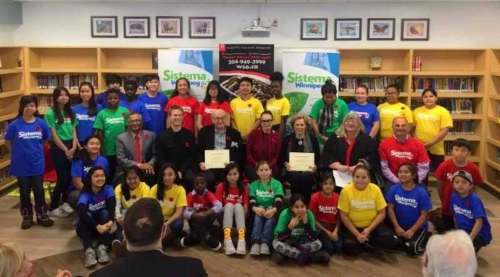 Supplied
Michael Nozick and Tannis Richardson (holding certificates) are lauded at Elwick Community School Thursday after donating $500,000 each to support Sistema Winnipeg.