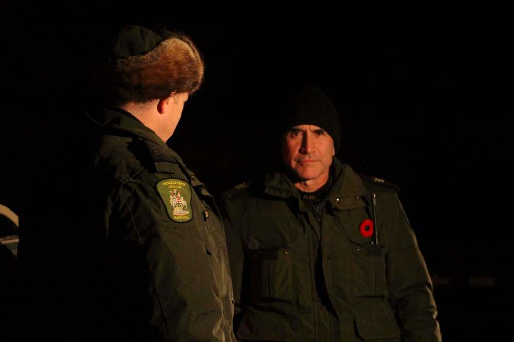 RYAN THORPE / WINNIPEG FREE PRESS
Somewhere in southwestern Manitoba, conservation officer Gerry Rosset, right, talking with conservation officer Shaun Bobier as the overnight operation targeting illegal night hunters wraps up.