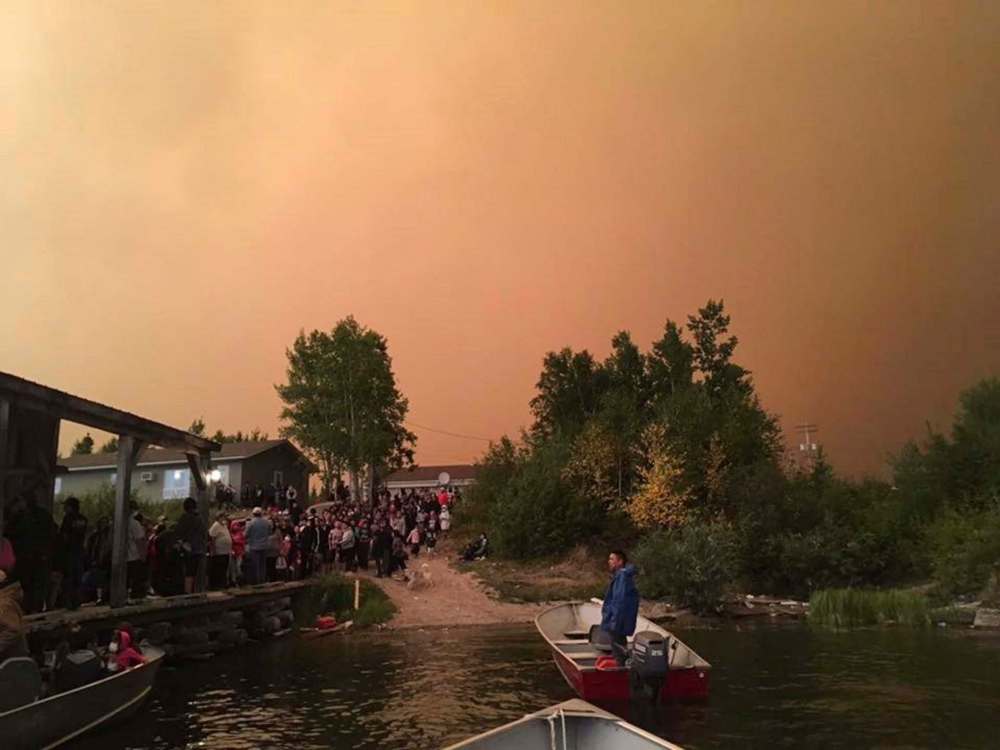 The Canadian Press files
Members of Wasagamack First Nation flee the wildfires on Aug. 29. Liberal MLA Judy Klassen alleges the six-kilometre evacuation by boat from Wasagamack to St. Theresa Point led to two miscarriages.