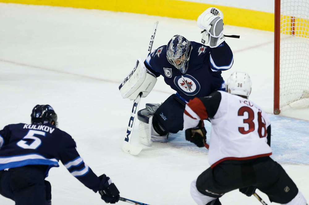 JOHN WOODS / WINNIPEG FREE PRESS
Connor Hellebuyck saves the shot from Arizona Coyotes' Derek Stepan as Christian Fischer (36) looks for a rebound and defenceman Dmitry Kulikov defends during the second period Tuesday.