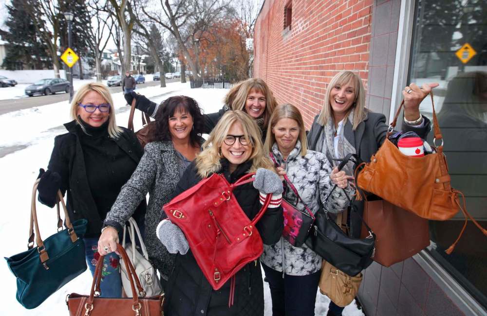 RUTH BONNEVILLE / WINNIPEG FREE PRESS
Sharon Evans (front) was inspired to start Handbags of Hope, filling purses with essential items for homeless women, with the help of Tracey Kleysen (from back left), Cathy Jowett, Silke Blaine, Shauna Angers and Karen Burns.