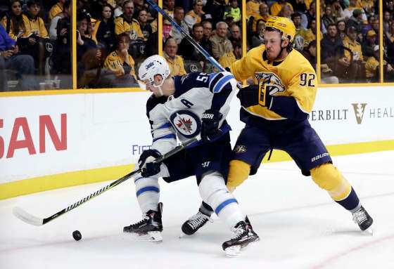Winnipeg Jets center Mark Scheifele (55) and Nashville Predators center Ryan Johansen (92) battle for the puck in the first period of an NHL hockey game Monday, Nov. 20, 2017, in Nashville, Tenn. (AP Photo/Mark Humphrey)