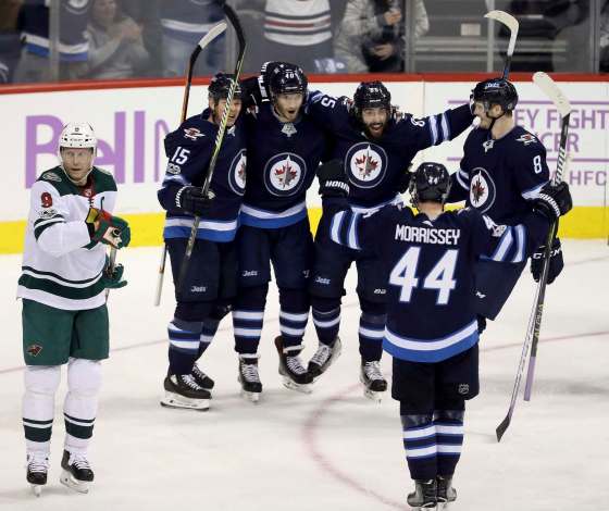 THE CANADIAN PRESS/Trevor HaganWinnipeg Jets' Matt Hendricks, Joel Armia, Mathieu Perreault, Josh Morrissey and Jacob Trouba celebrate after Armia scored during first period NHL hockey action against the Minnesota Wild Monday.