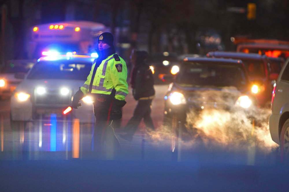 RUTH BONNEVILLE / WINNIPEG FREE PRESS
A police officer directs traffic on St. Mary Avenue after the Jets game and start of Santa Claus Parade on Saturday.
