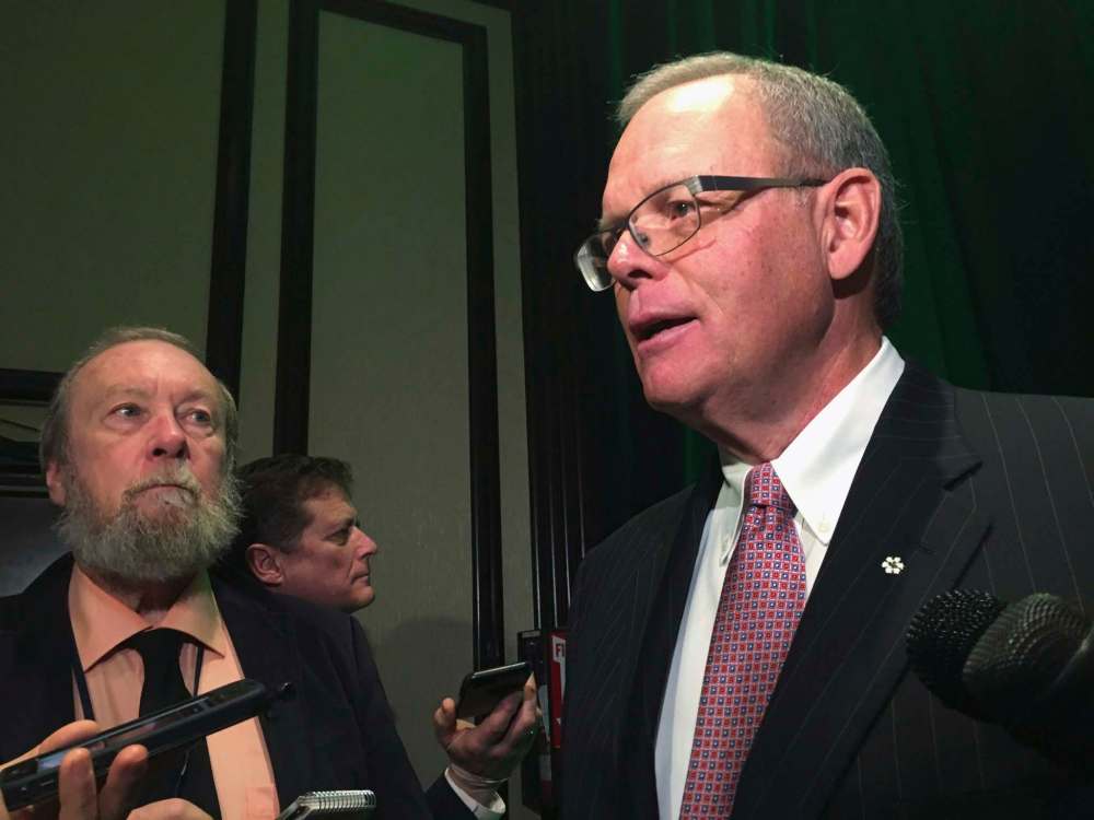Sanford Riley, board chair at Manitoba Hydro, speaks to reporters after a speech to business leaders in Winnipeg on Friday, Dec. 1, 2017. Riley is hoping the Manitoba government will use some of the money collected through its proposed carbon tax to offset rising hydro rates for low-income earners. (Steve Lambert / The Canadian Press)