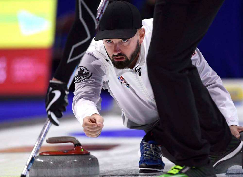 Skip Reid Carruthers makes a shot during a draw against Team McEwen at the 2017 Roar of the Rings Canadian Olympic Curling Trials in Ottawa on Saturday, Dec. 2, 2017.