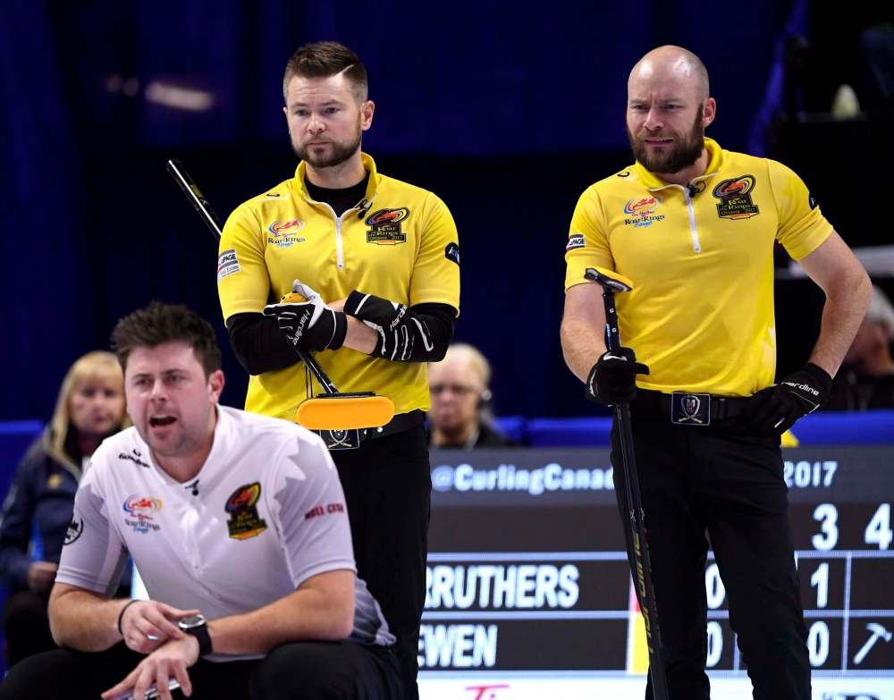 Skip Mike McEwen and third B.J. Neufeld watch a shot as Team Carruthers third Braeden Moskowy calls to his sweepers at the 2017 Roar of the Rings Canadian Olympic Curling Trials in Ottawa on Saturday, Dec. 2, 2017.