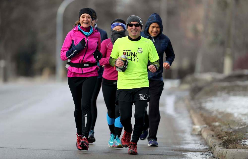TREVOR HAGAN / WINNIPEG FREE PRESS
Retired teacher Mike Bennett (centre) ran 58.341 kilometres Sunday to raise funds for Art City. There are still some donations left to tally, but at last count, the total was $5,000.