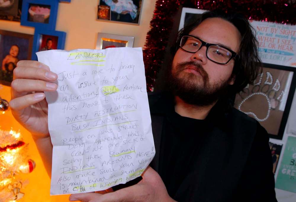 BORIS MINKEVICH / WINNIPEG FREE PRESS
Tashie McKay displays the hate mail left in his mailbox. He says he’s no stranger to racism.