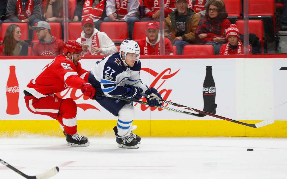 Winnipeg Jets left wing Nikolaj Ehlers (27) skates past Detroit Red Wings center Frans Nielsen (51) in the first period of an NHL hockey game Tuesday, Dec. 5, 2017, in Detroit. (AP Photo/Paul Sancya)