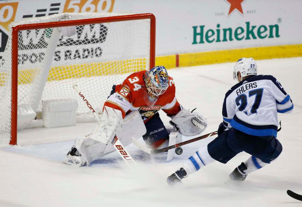 AP Photo/Wilfredo Lee
Winnipeg Jets left wing Nikolaj Ehlers attempts a shot at Florida Panthers goalie James Reimer during the second period, Thursday, in Sunrise, Fla.