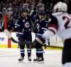 THE CANADIAN PRESS/Trevor Hagan
Winnipeg Jets' Adam Lowry and Andrew Copp celebrate after Lowry scored against the Arizona Coyotes during second period in Winnipeg, Tuesday, November 14.