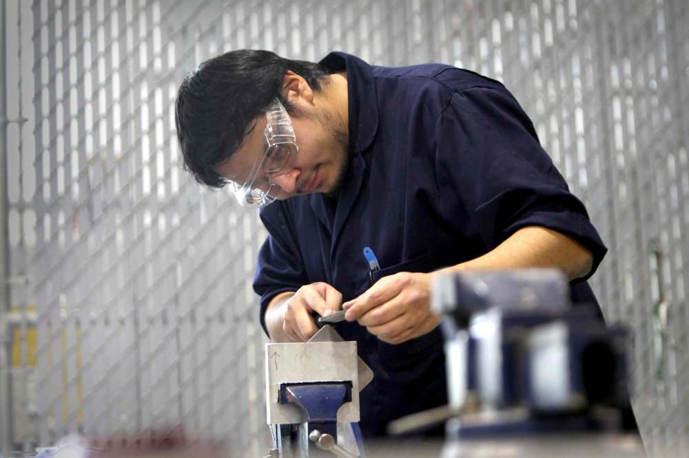 RUTH BONNEVILLE / WINNIPEG FREE PRESS
Michael Kirkness files a plate of medal in the Machining class with Centre for Aboriginal Human Resource Development Inc.