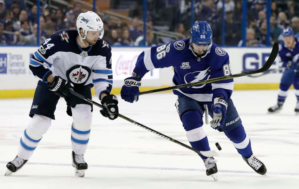 CHRIS O'MEARA / THE ASSOCIATED PRESS
Tampa Bay Lightning right wing Nikita Kucherov (86) bats the puck away from Winnipeg Jets defenseman Josh Morrissey (44) during the second period of an NHL hockey game Saturday, Dec. 9, 2017, in Tampa, Fla.