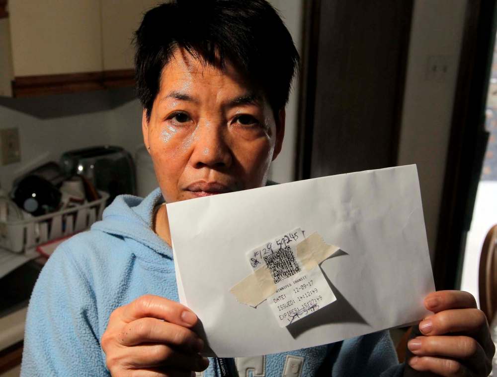 BORIS MINKEVICH / WINNIPEG FREE PRESS
Cathy Wong and the expired transit bus transfer.