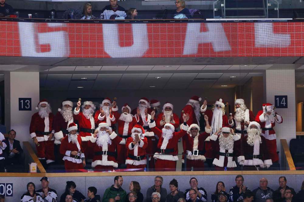 JOHN WOODS / WINNIPEG FREE PRESS
A box of Santas celebrate Mark Scheifele's third-period goal Sunday.