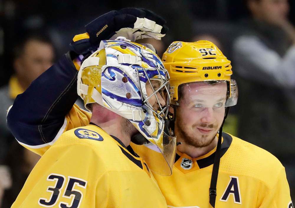 Nashville Predators center Ryan Johansen (92) congratulates goalie Pekka Rinne (35), of Finland, after the Predators beat the Chicago Blackhawks 3-2 in an NHL hockey game Tuesday, Nov. 28, 2017, in Nashville, Tenn. (AP Photo/Mark Humphrey)