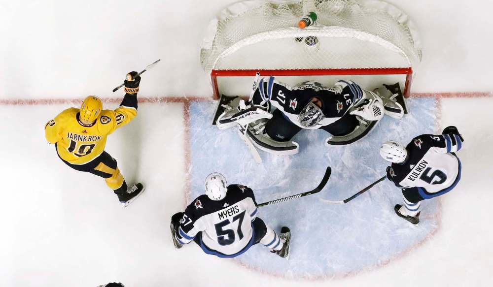 Nashville Predators center Calle Jarnkrok celebrates after scoring a goal against Winnipeg Jets goalie Connor Hellebuyck in the second period of an NHL hockey game Tuesday, Dec. 19, 2017, in Nashville. (AP Photo/Mark Humphrey)