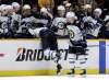 Blake Wheeler, centre, is pulled over the boards and into the bench area by teammates after he scored an empty-net goal to secure the 6-4 win over the Predators in the final seconds of the game Tuesday in Nashville. (Mark Humphrey / The Associated Press)