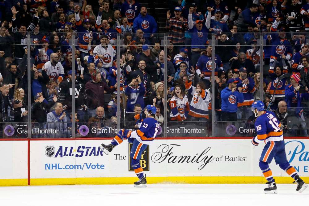 New York Islanders' Mathew Barzal celebrates scoring his second goal in the first period. Barzal went on to score again to complete a hat trick. (Adam Hunger / The Associated Press)