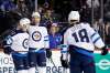 Winnipeg Jets' Tucker Poolman, second left, is congratulated by Jets' Nikolaj Ehlers after scoring his first NHL goal against the New York Islanders. (Adam Hunger / The Associated Press)
