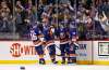 Mathew Barzal, second right, celebrates after scoring his third goal of the game against the Jets. (Adam Hunger / The Associated Press)