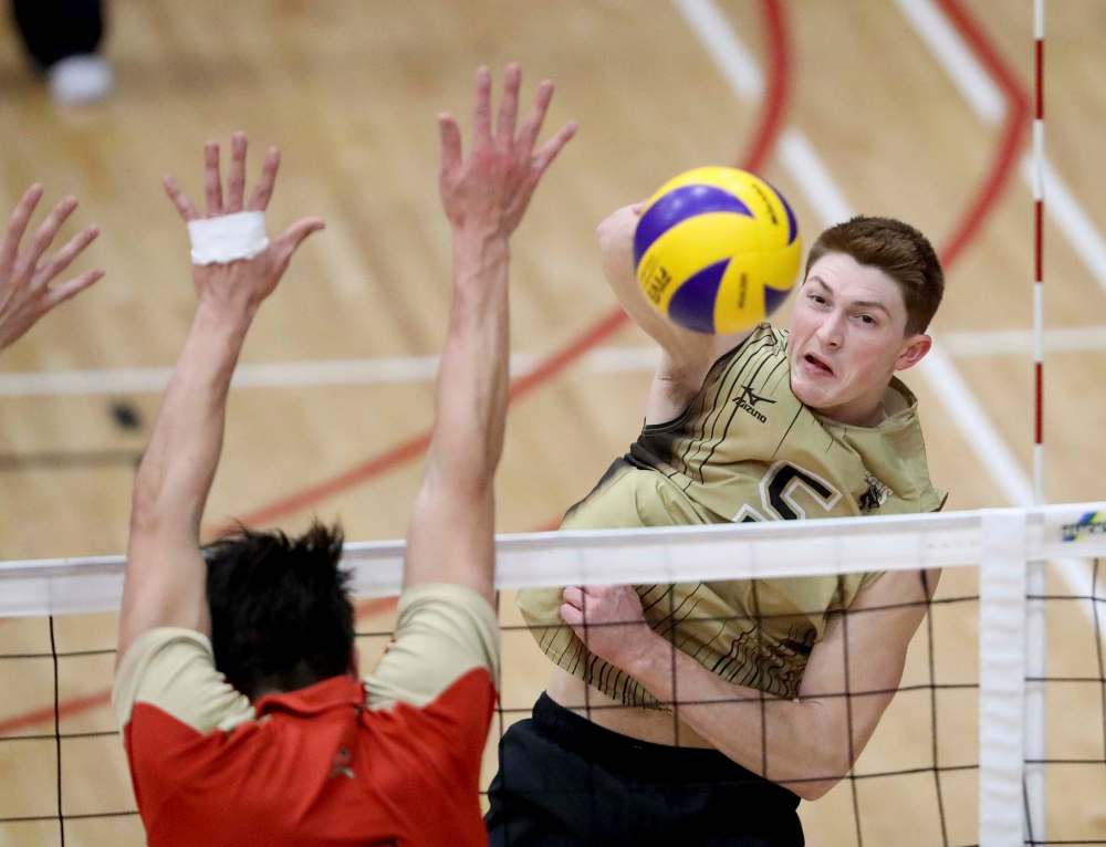 PHOTOS BY TREVOR HAGAN / WINNIPEG FREE PRESS
University of Manitoba's Scott Vercaigne (5), hits past the Université Laval Rouge Et Or block, during Wesmen Classic volleyball at the Duckworth Centre at the University of Winnipeg Saturday.