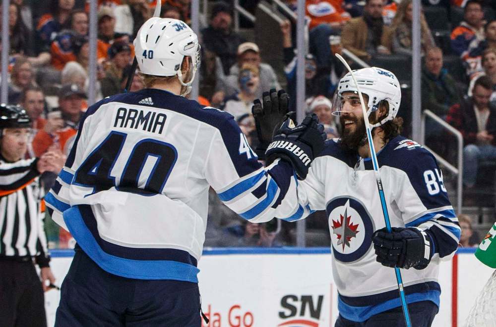 Jason Franson
/ The Canadian Press
Winnipeg Jets Joel Armia (40) and Mathieu Perreault (85) celebrate a goal against the Edmonton Oilers during third period NHL action in Edmonton on Sunday, December 31, 2017.