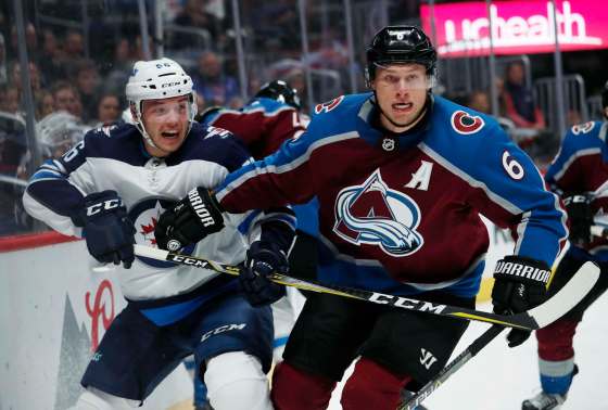 (AP Photo/David Zalubowski)Colorado Avalanche defenseman Erik Johnson, right, checks Winnipeg Jets center Marko Dano, of Austria, as they pursue the puck in the second period of an NHL hockey game Tuesday, Jan. 2, 2018, in Denver.