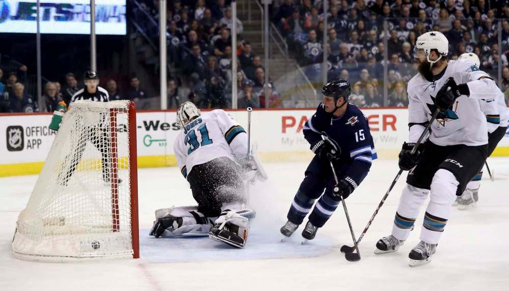 TREVOR HAGAN / THE CANADIAN PRESS
Winnipeg Jets centre Matt Hendricks scores on San Jose Sharks goaltender Martin Jones as Brent Burns looks on during first-period NHL action at Bell MTS Place Sunday.