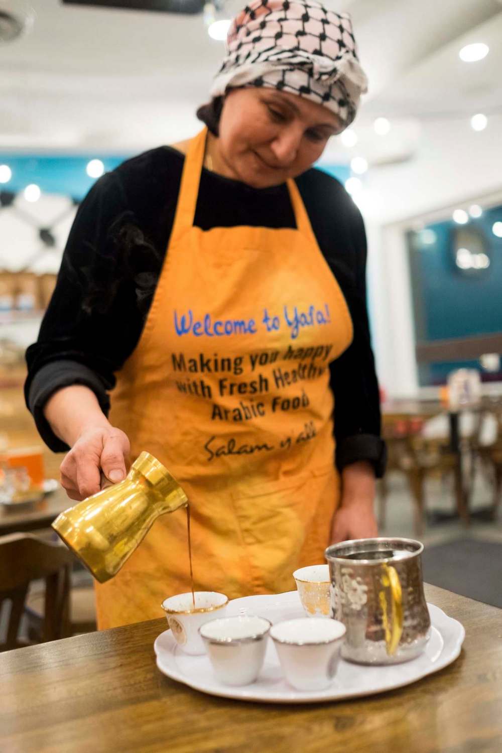 Daniel Crump / Winnipeg Free Press
Yafa Cafe’s co-owner Rana Abdulla pours turkish coffee.