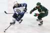 Winnipeg Jets' Joel Armia (40) controls the puck against Minnesota Wild's Matt Cullen (7) in the third period of an NHL hockey game Saturday, Jan. 13, 2018, in St. Paul, Minn. Minnesota won 4-1. (AP Photo/Stacy Bengs)