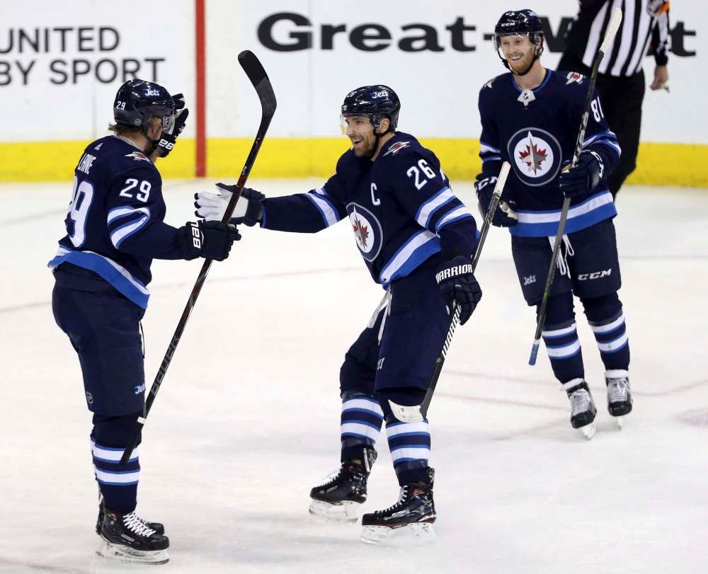 TREVOR HAGAN / THE CANADIAN PRESS
Winnipeg Jets' Patrik Laine (29), Blake Wheeler (26) and Kyle Connor (81) celebrate after Laine scored during first period NHL hockey action against the Vancouver Canucks, in Winnipeg, Sunday, January 21, 2018.