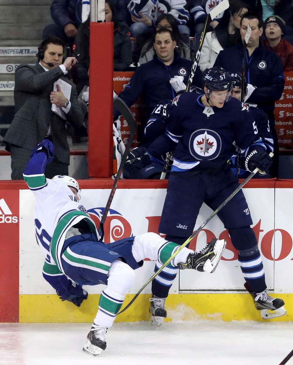 TREVOR HAGAN / THE CANADIAN PRESS
Vancouver Canucks' Thomas Vanek (26) is hit by Winnipeg Jets' Tyler Myers (57) during first period NHL hockey action.