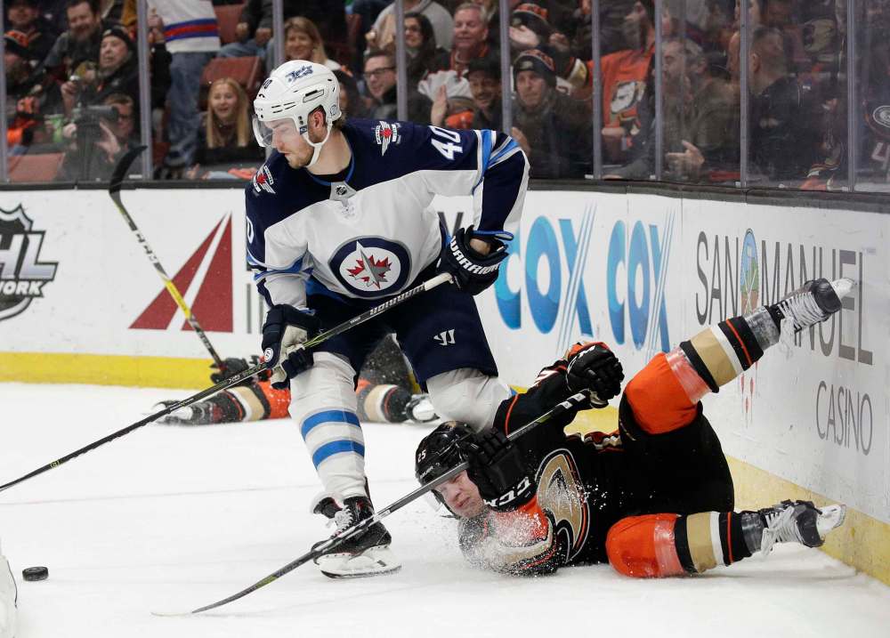 (AP Photo/Jae C. Hong)
Anaheim Ducks' Ondrej Kase, bottom, of the Czech Republic, falls as Winnipeg Jets' Joel Armia, of Finland, moves the puck during the second period of an NHL hockey game Thursday, Jan. 25, 2018, in Anaheim, Calif.